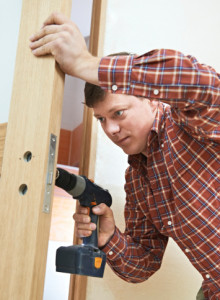 carpenter at door lock installation